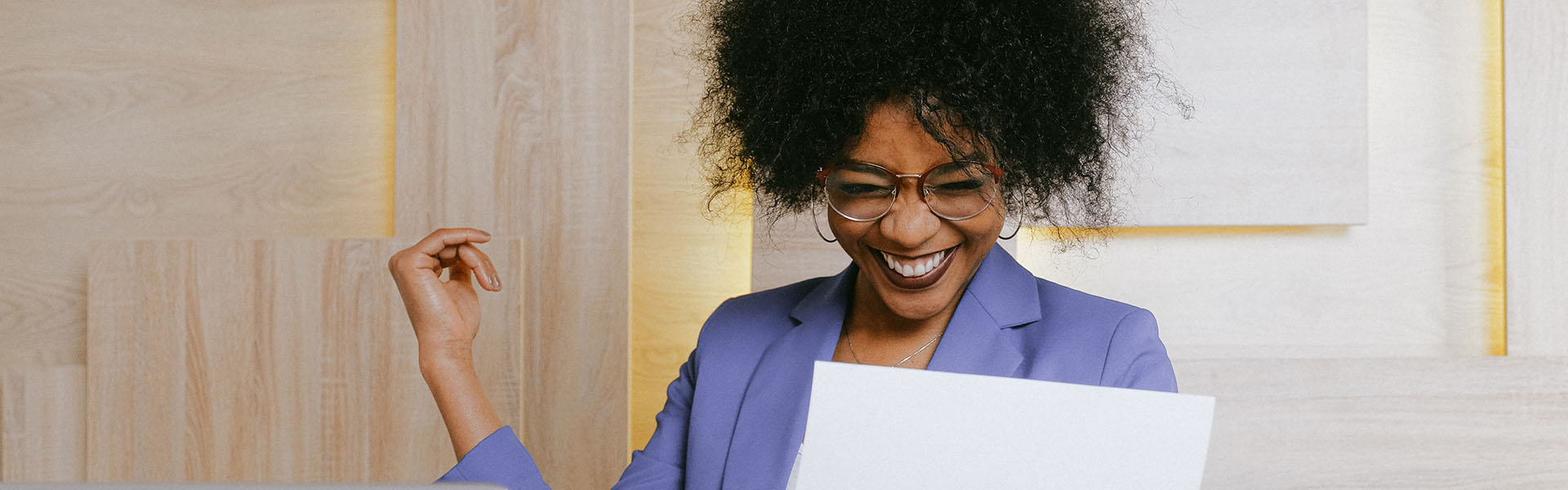 Woman holding paper and smiling